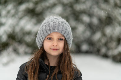 Portrait of cute smiling girl wearing warm clothing during winter