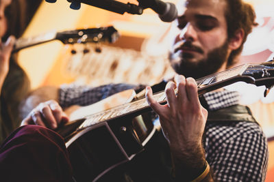 Low angle view of man playing guitar