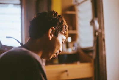 Close-up of man smoking window at home