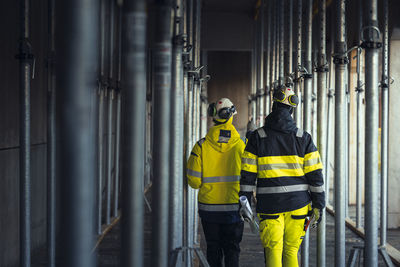 Rear view of engineers at building site