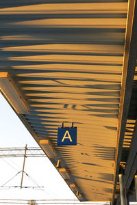 Low angle view of information sign hanging on ceiling