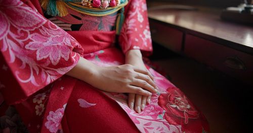 Midsection of woman with bouquet