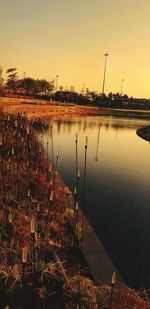 Scenic view of lake against clear sky during sunset