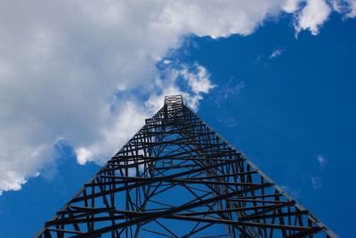 Low angle view of communications tower against blue sky