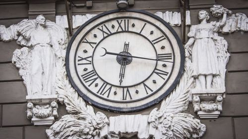 Statue of clock on column