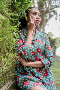 Portrait of young woman sitting on field