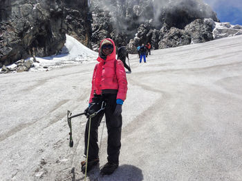 A group of hikers in warm clothing descending margherita glacier in the rwenzori