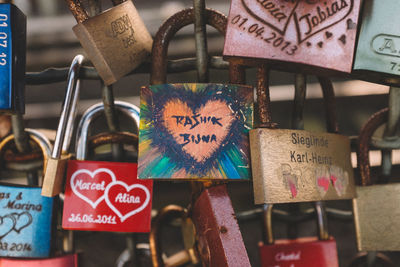 Close-up of love locks hanging on bridge