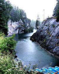 Scenic view of waterfall in forest against sky