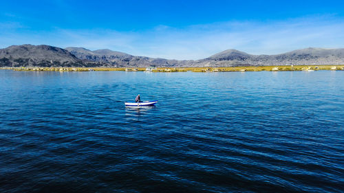 Man on boat in river against sky