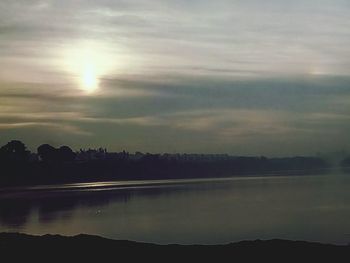 Scenic view of lake against cloudy sky