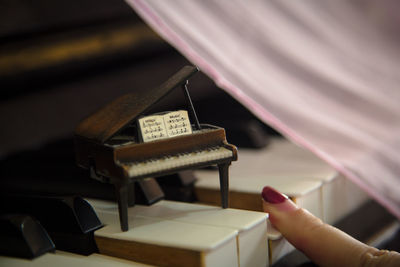 Cropped image of woman playing piano