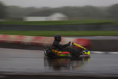 Blurred motion of man riding motorcycle on water