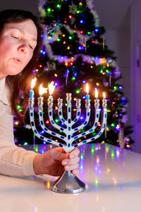 Portrait of woman holding christmas tree