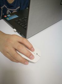 Midsection of man using laptop on table