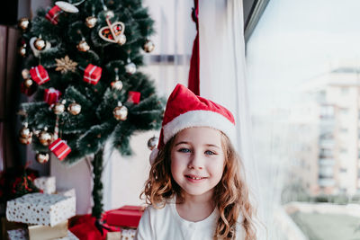 Close-up of smiling girl at home during christmas 