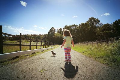 Woman with dog against sky