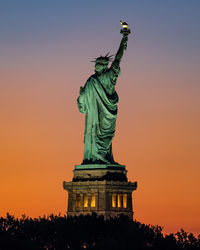 Low angle view of statue against sky during sunset