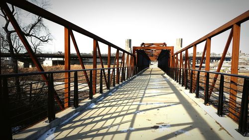 Footbridge against clear sky