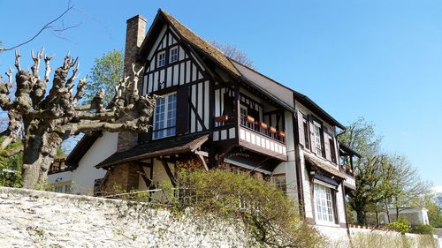 Low angle view of built structure against clear blue sky