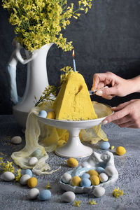 Traditional easter orthodox curd cake with yellow flowers on a grey table