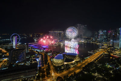 High angle view of illuminated ferris wheel at night