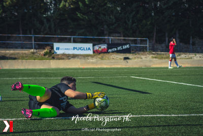 Man playing with ball on grass