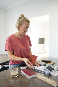 Woman looking at swatches in kitchen