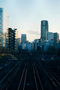 High angle view of railroad tracks in city against sky