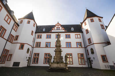 Low angle view of buildings against sky in city