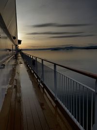 Pier over sea against sky during sunset