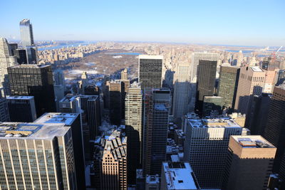 Aerial view of buildings in city against sky