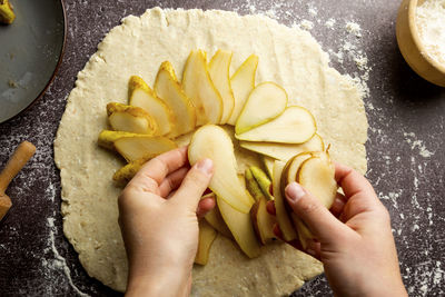 Cropped image of hand holding food at home