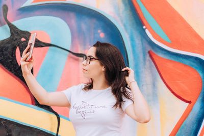 Woman with graffiti on wall