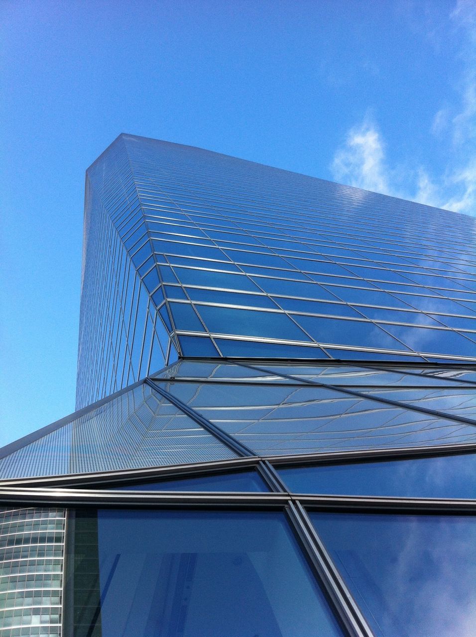 low angle view, architecture, built structure, building exterior, modern, blue, office building, sky, skyscraper, tall - high, building, city, tower, pattern, glass - material, day, clear sky, reflection, outdoors, no people