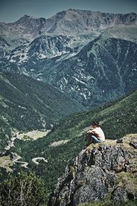 Female hiker sitting on mountain