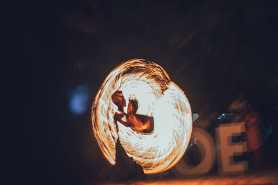 Illuminated light painting on fire at night