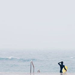 Rear view of male surfer in the sea