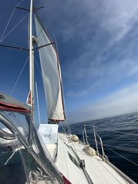 Sailboat sailing on sea against sky