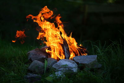 Close-up of bonfire on field at night