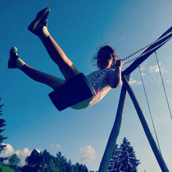 Low angle view of woman in swimming pool against sky