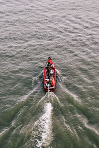 High angle view of people on boat in sea