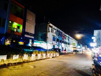 People in illuminated city at night