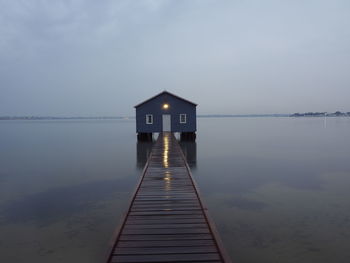 Pier over lake against sky