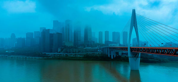 View of bridge and buildings against sky