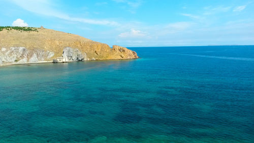 Scenic view of sea against cloudy sky