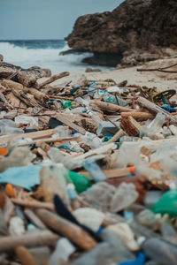 Close-up of pebbles on beach against sky