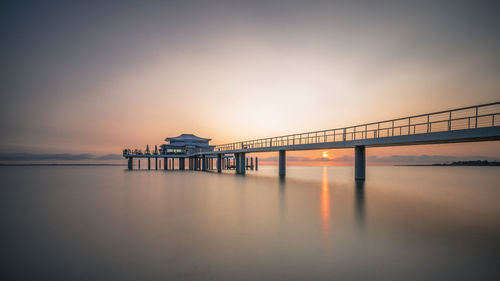 Bridge over sea during sunset