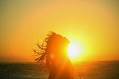 Sun shining through clouds over sea