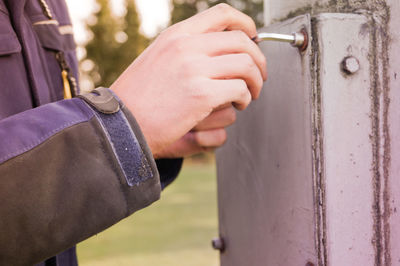 Cropped image of electrician working on fuse box